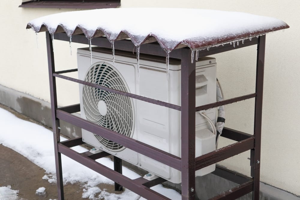 heat,pump,mounted,onto,the,wall,of,a,house,and