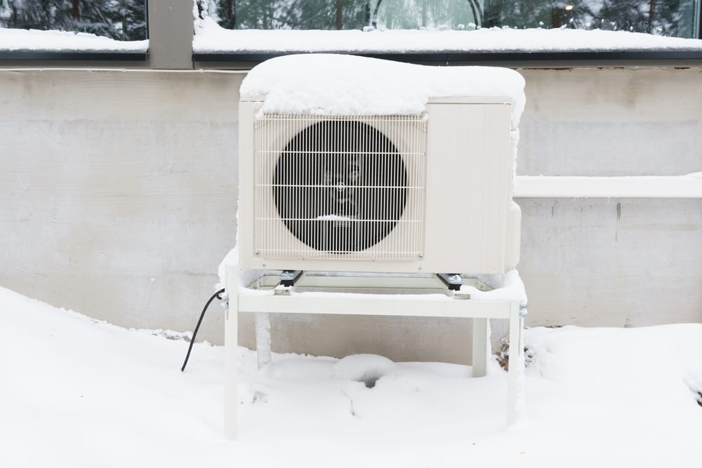 The outdoor unit of an air-source heat pump after a winter storm.